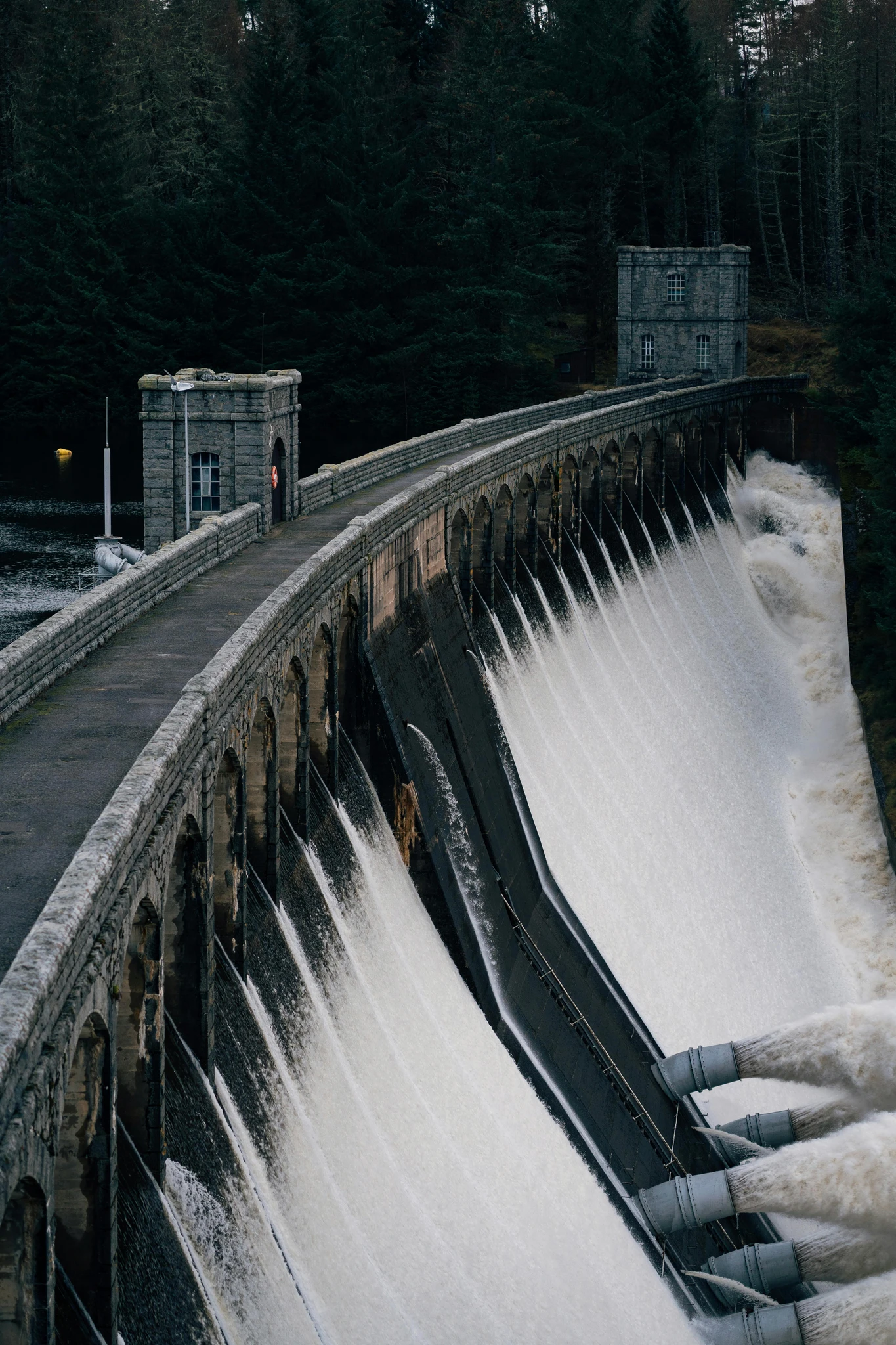 Water pouring over a dam spillway