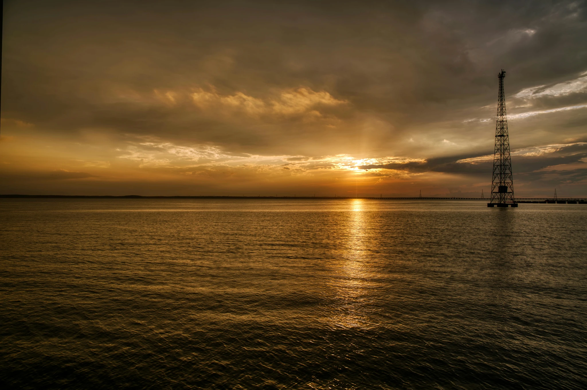 Sunset over calm coastal water