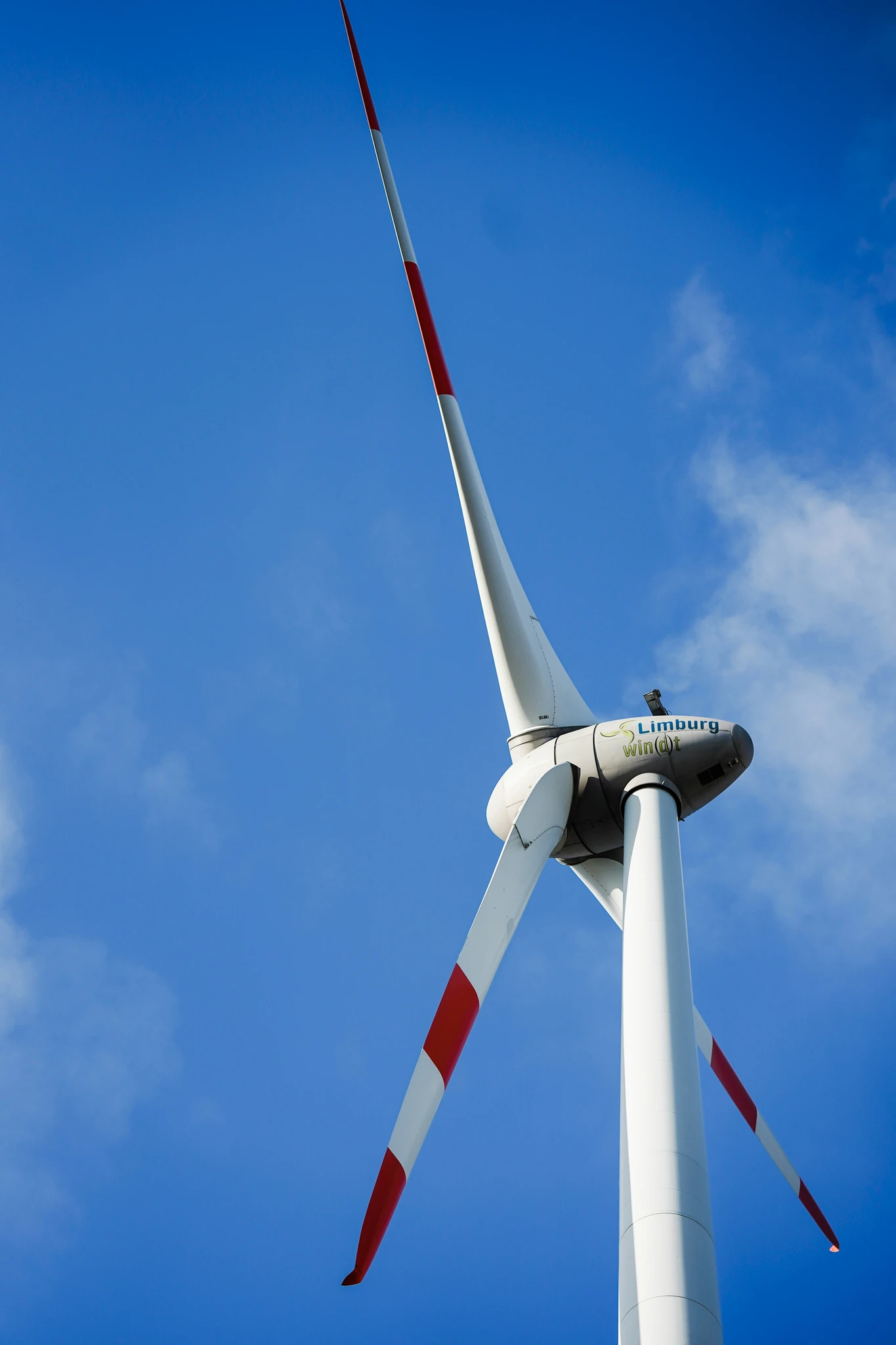 A wind turbine against a blue sky