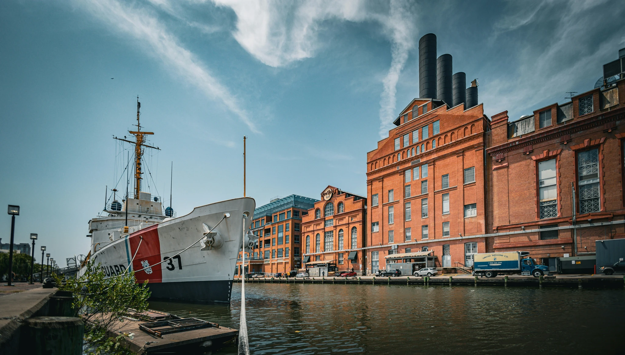 A ship moored beside brick warehouses on Baltimore’s waterfront