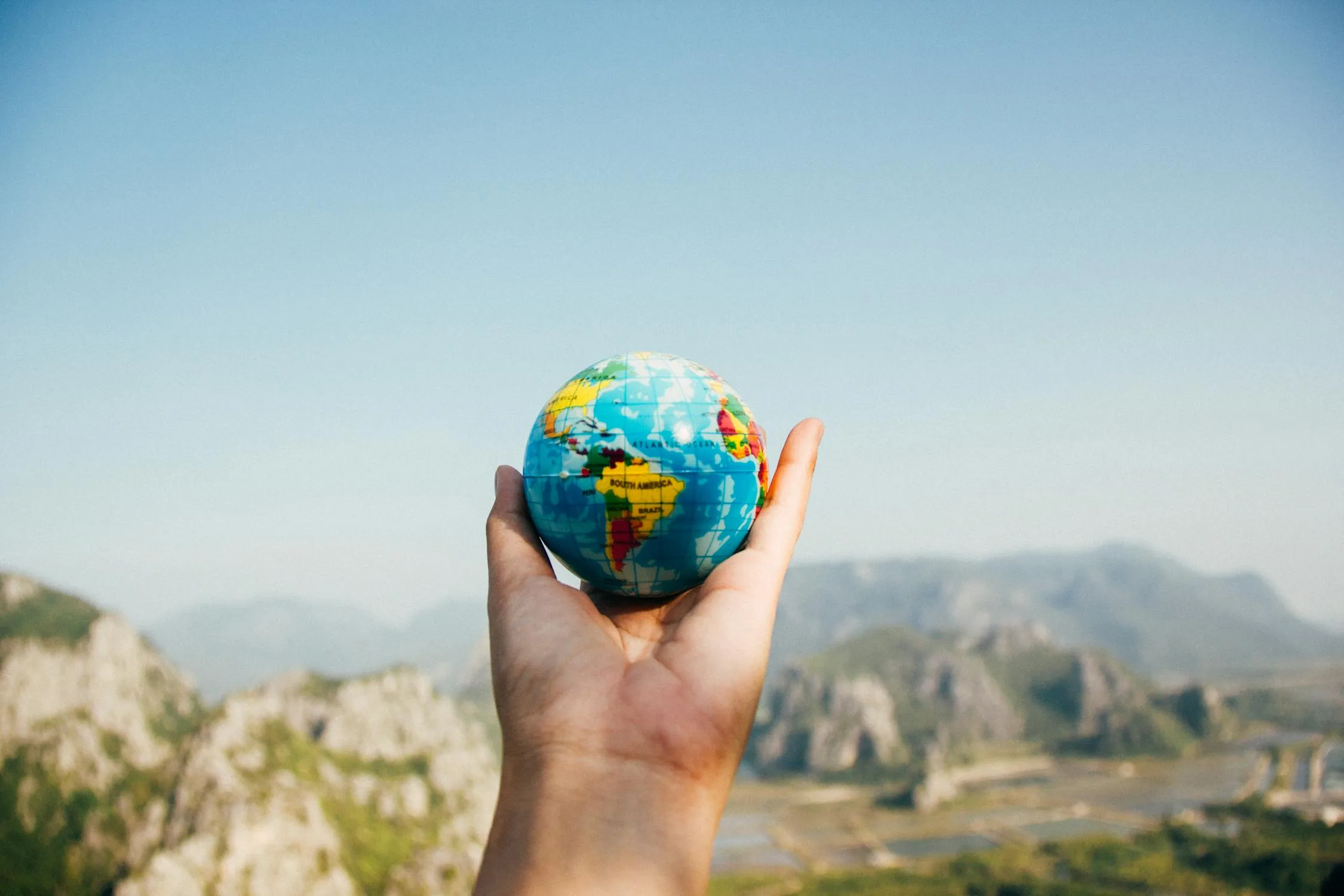 Globe on a desk with financial documents