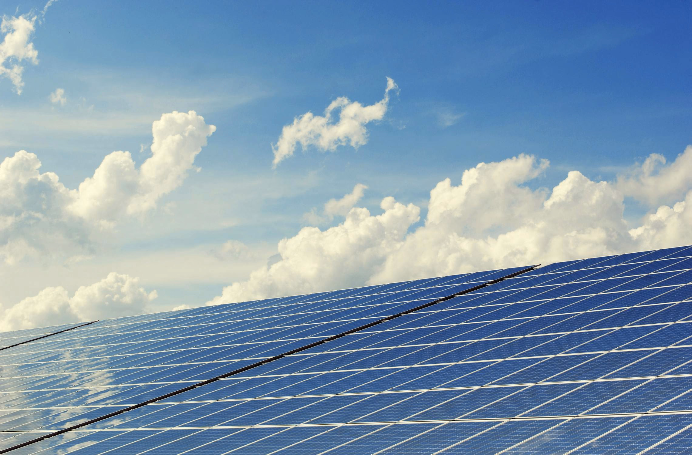 Solar panels and battery storage containers at a renewable energy facility