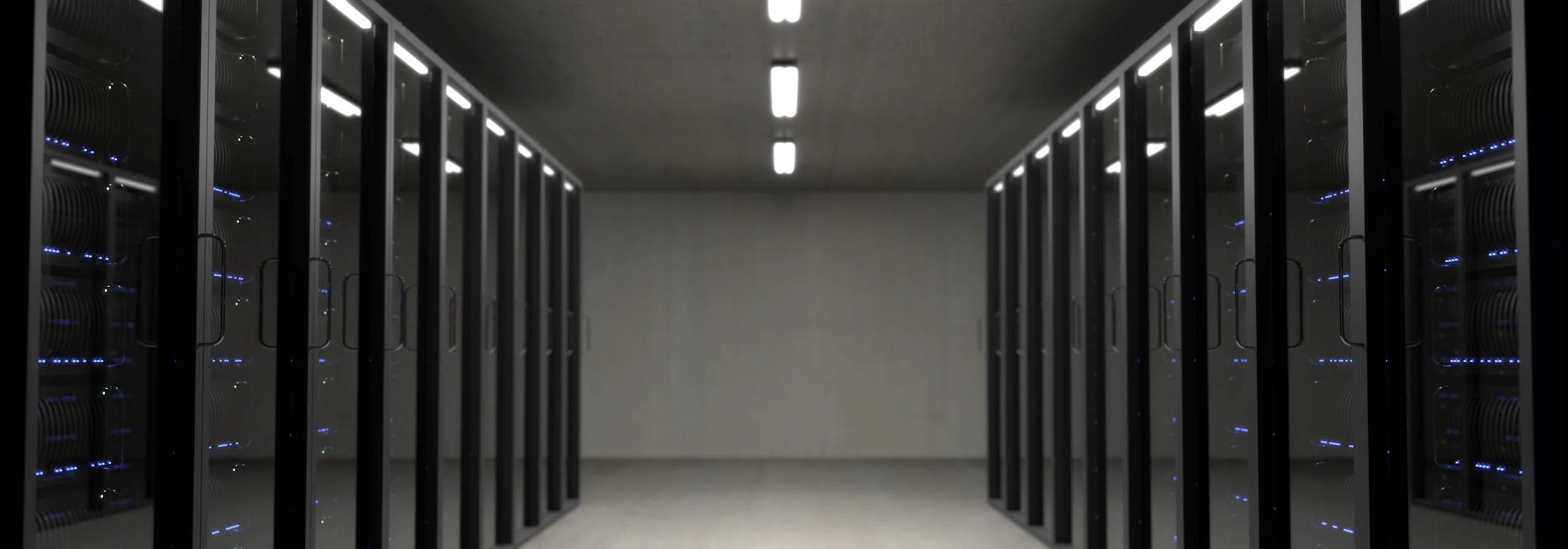 Server room with rows of illuminated data center equipment
