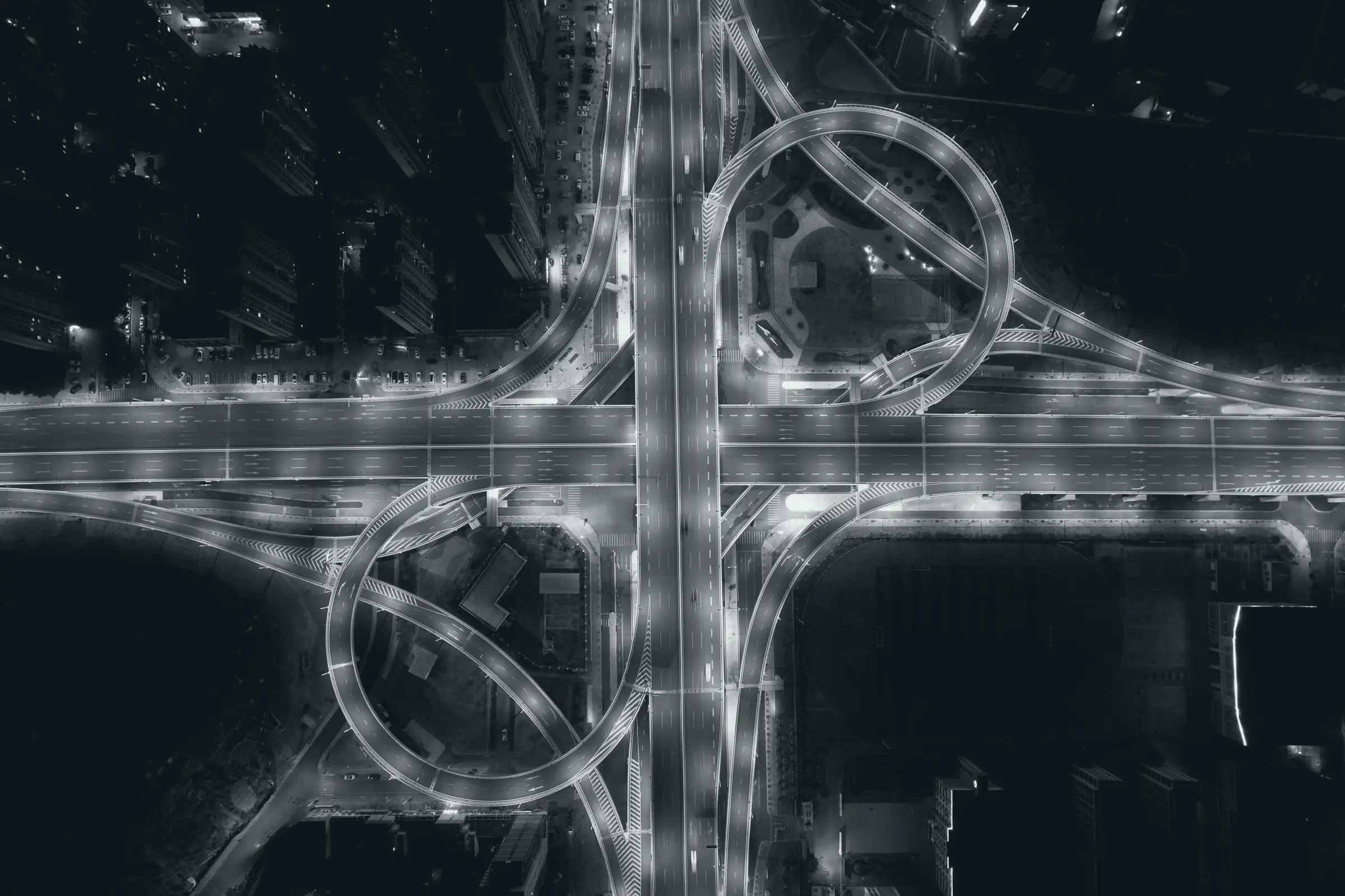 A highway interchange lit at night, seen from above