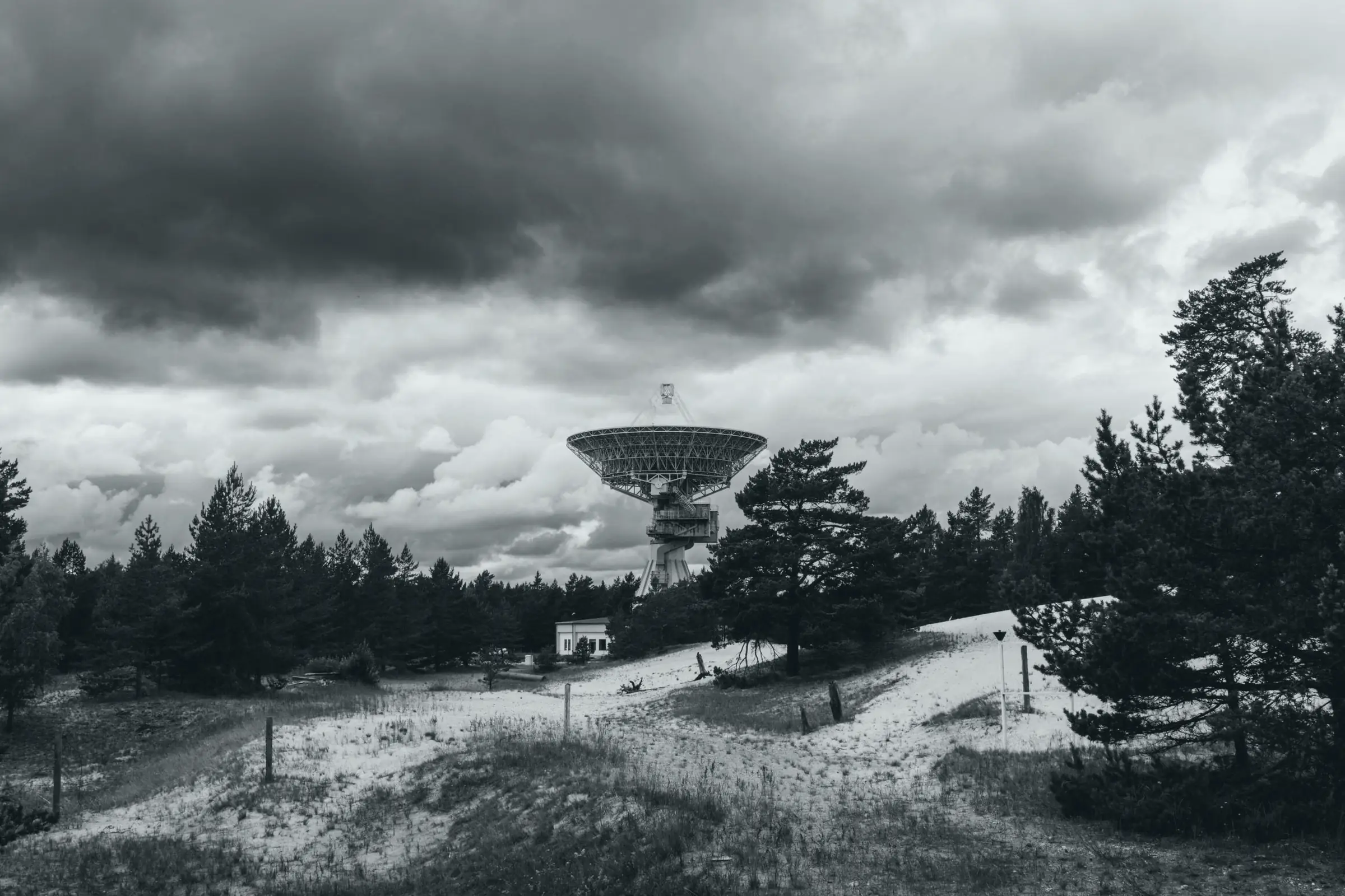 A radio telescope in Latvia under storm clouds